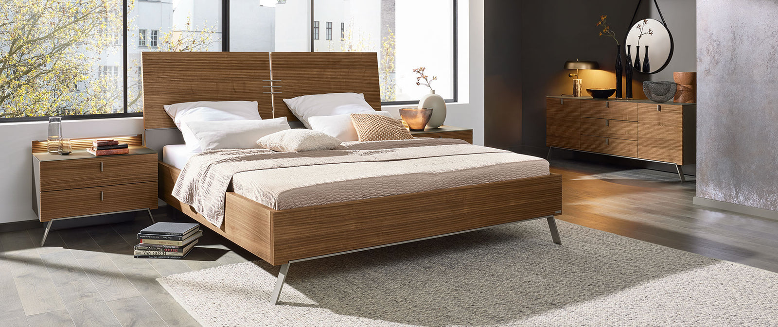 Modern bedroom with a wooden bed and minimal decor.
