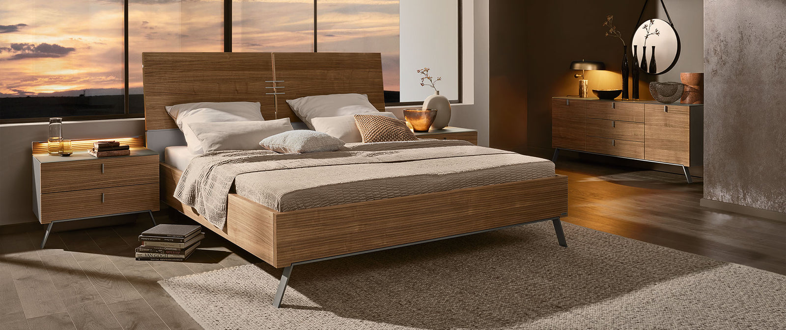 Modern bedroom with wooden bed and side tables.