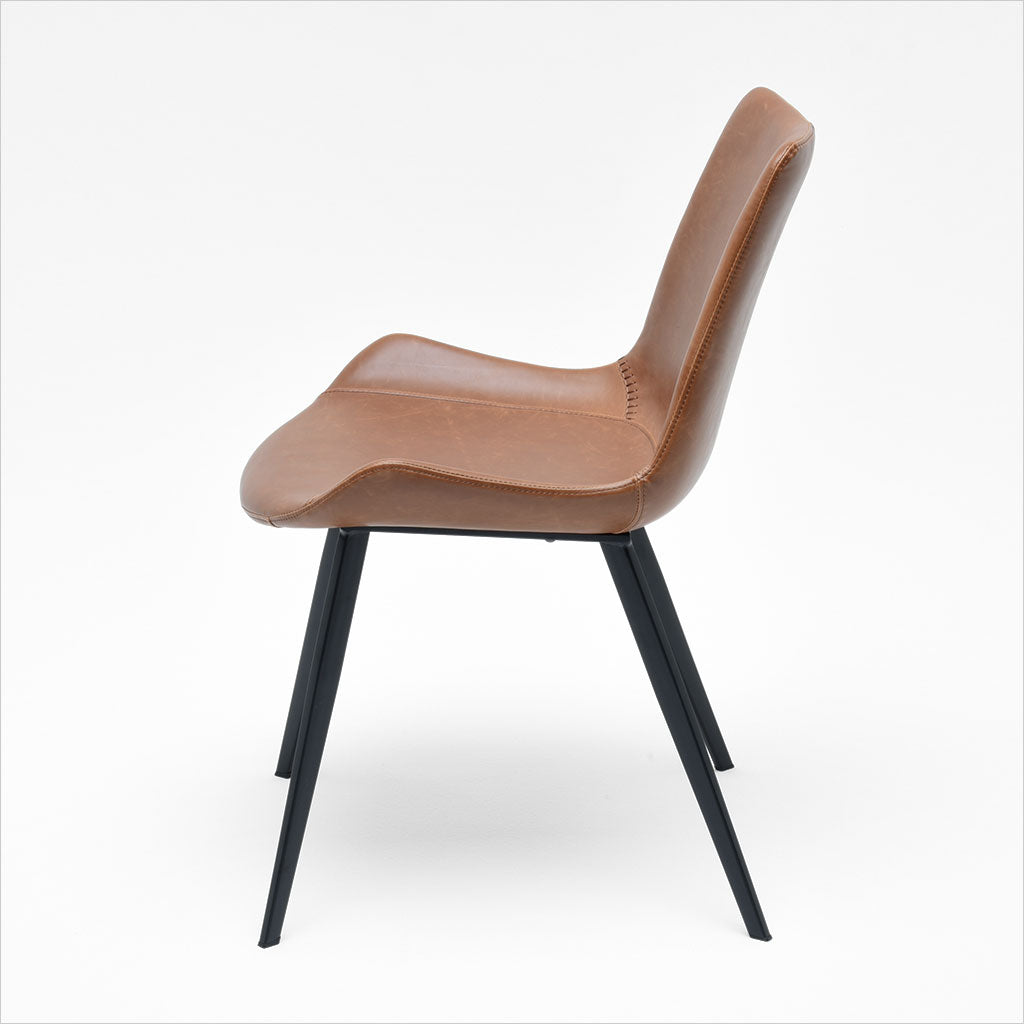 dining chair with baseball stitching along edges and curves