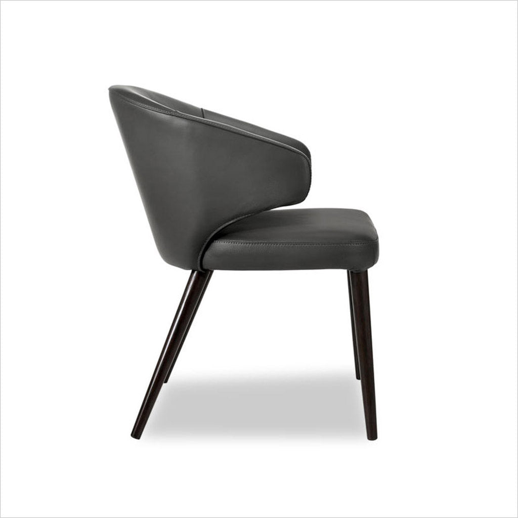 leather upholstered chair with arm and curved back