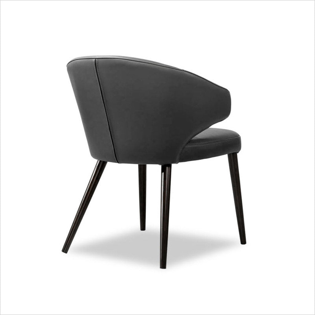 leather upholstered chair with arm and curved back