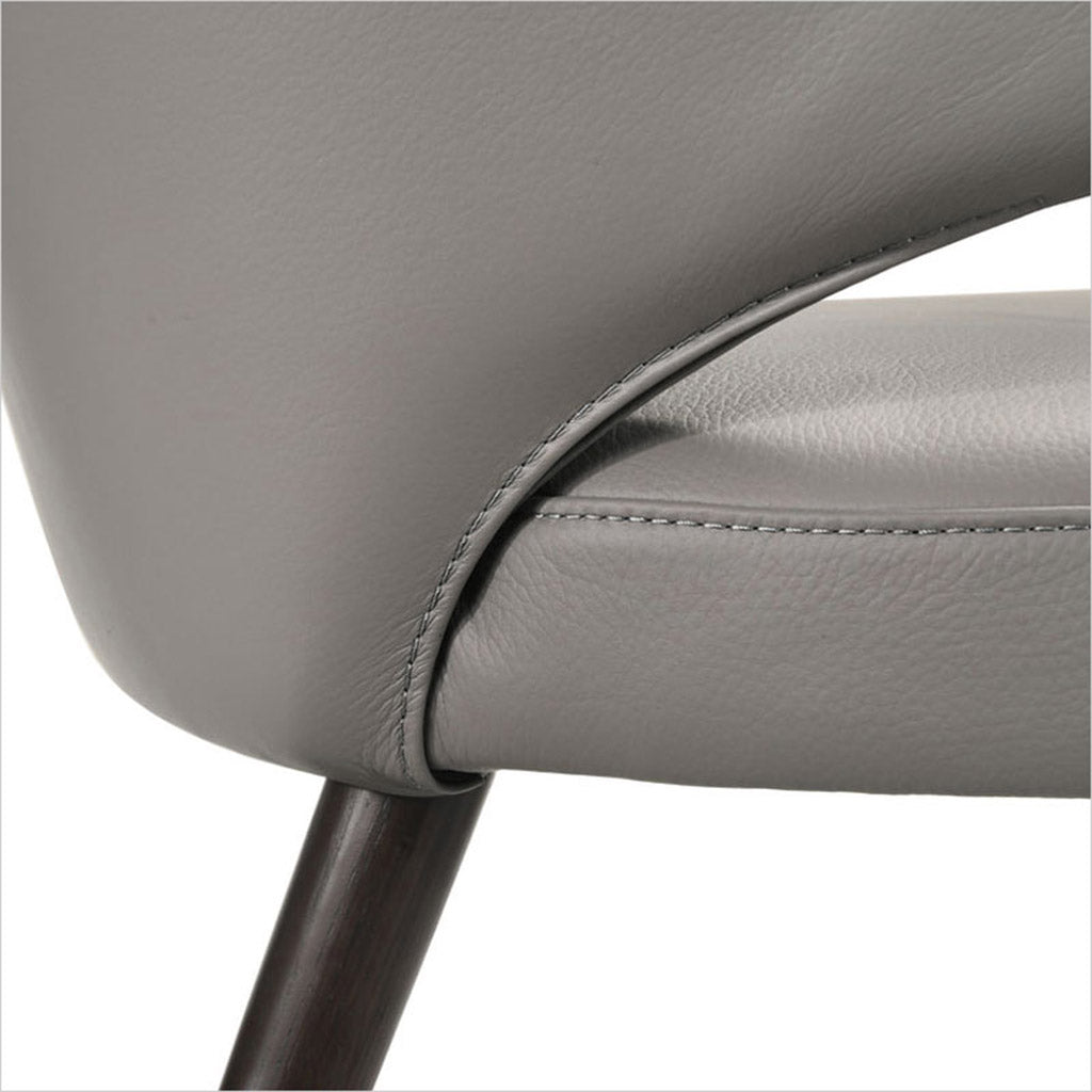 leather upholstered chair with arm and curved back