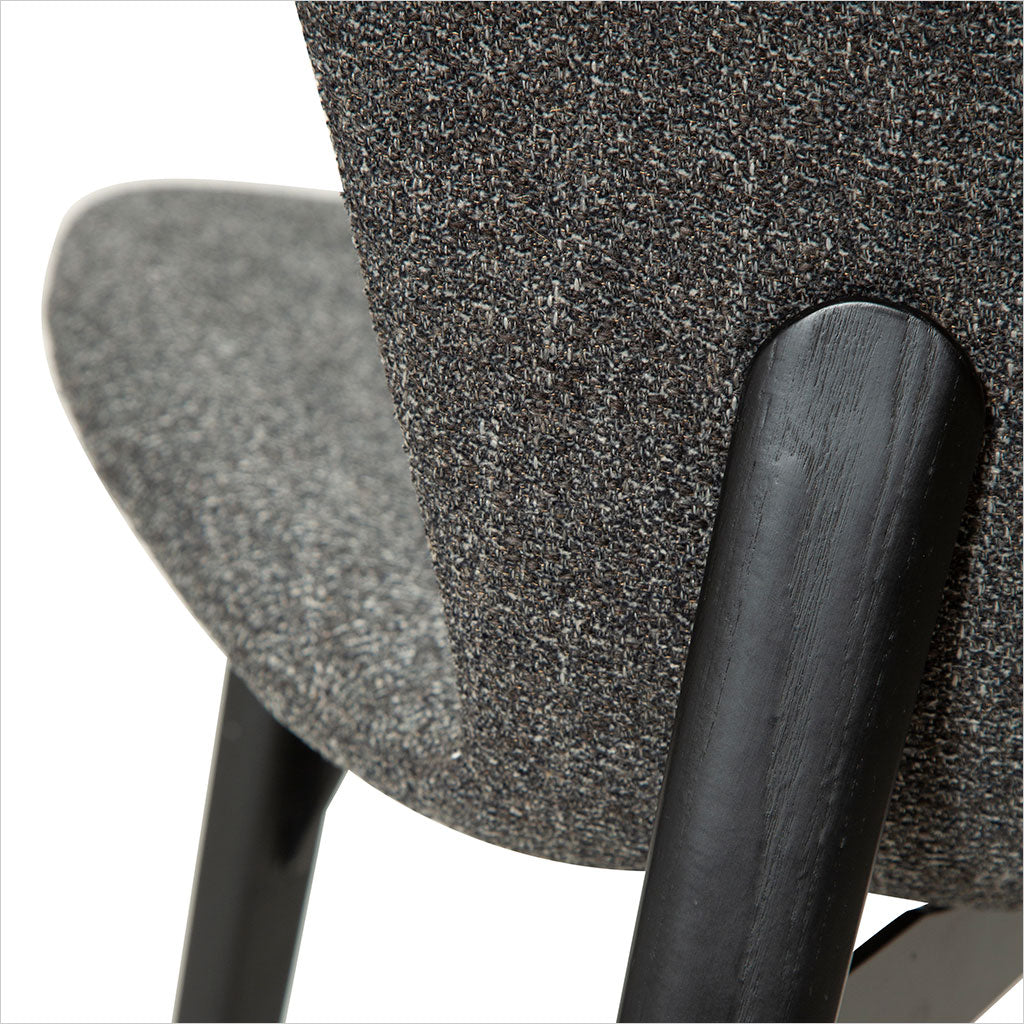 grey fabric dining chair with black legs