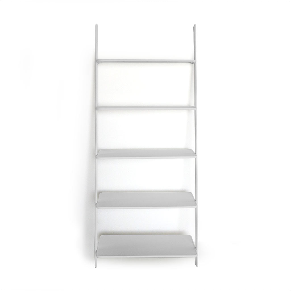 white leaning bookcase