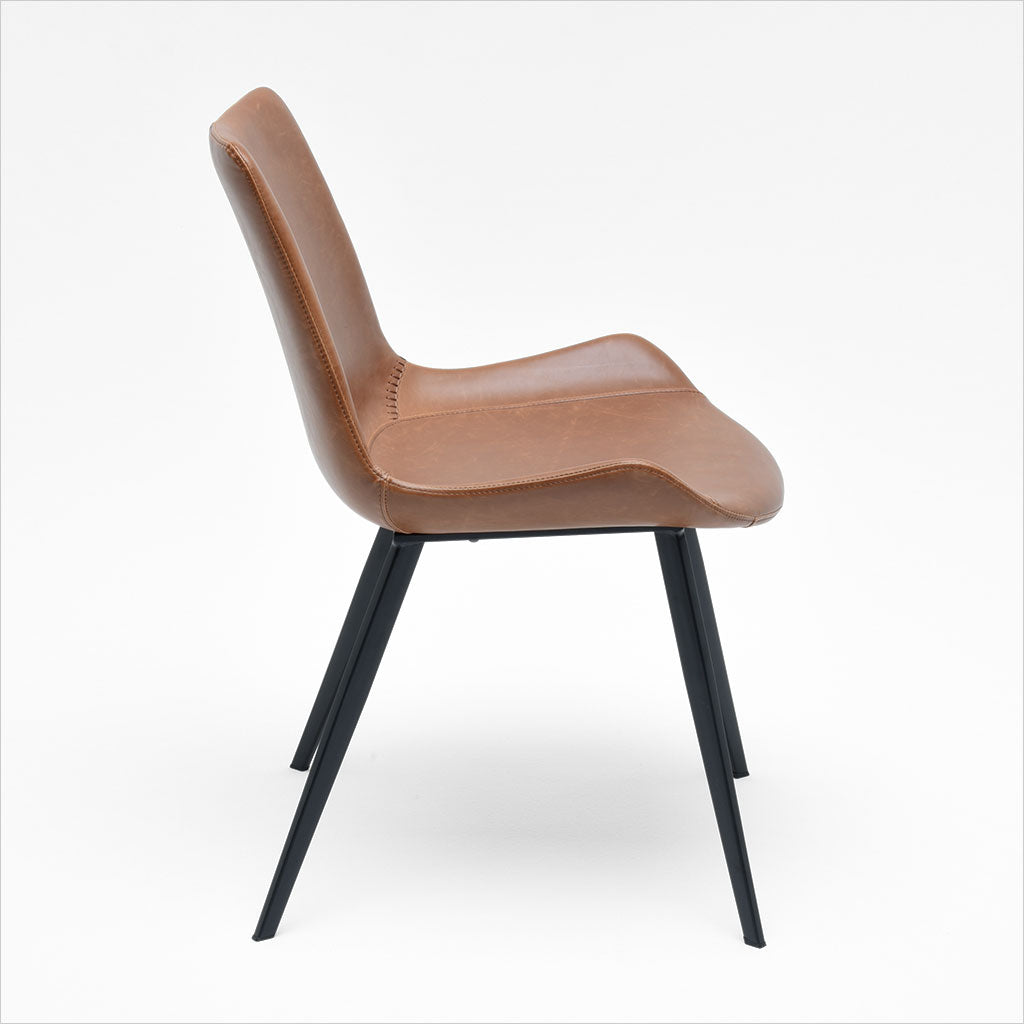 dining chair with baseball stitching along edges and curves