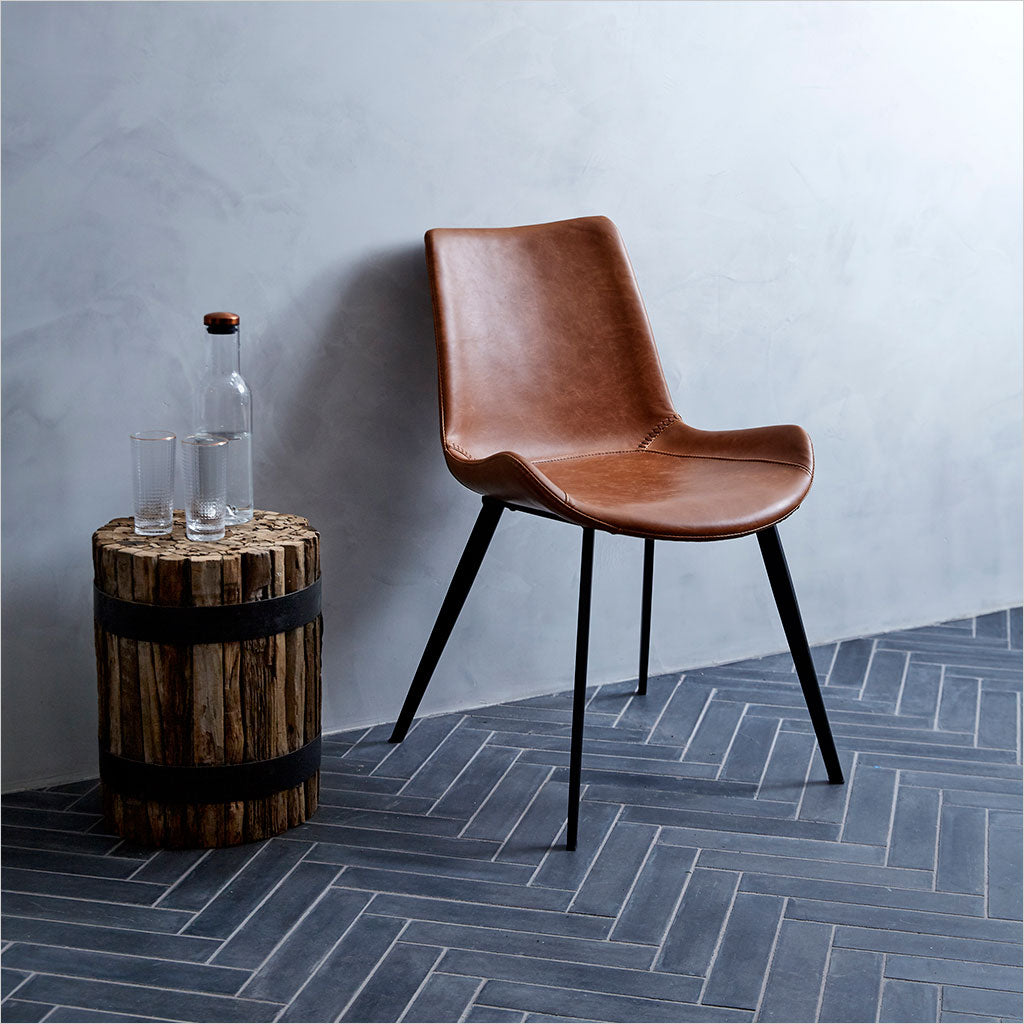 dining chair with baseball stitching along edges and curves