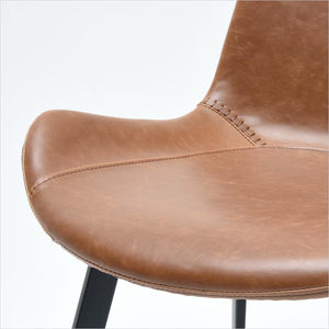 dining chair with baseball stitching along edges and curves