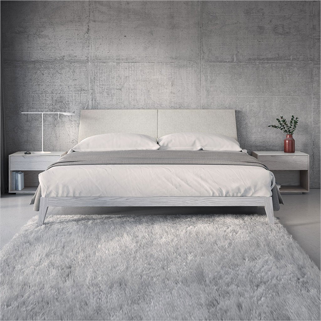 platform bed with upholstered headboard and light grey wood frame