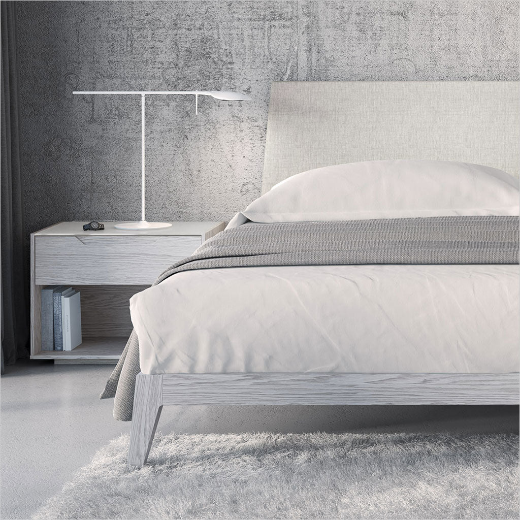 platform bed with upholstered headboard and light grey wood frame