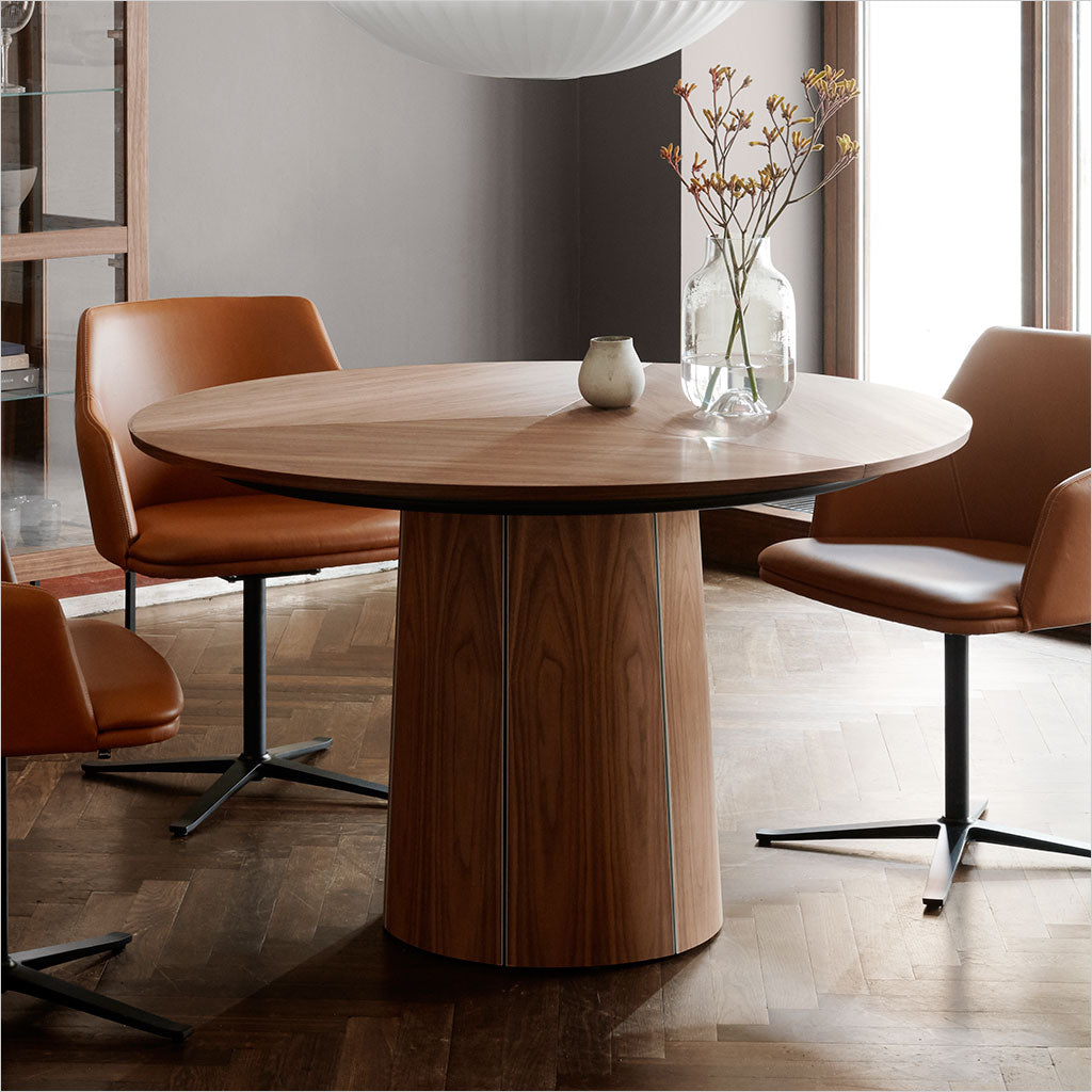 round dining table with extension leaves and pedestal base