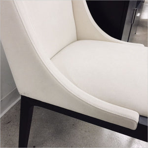 high back dining chair upholstered in white fabric
